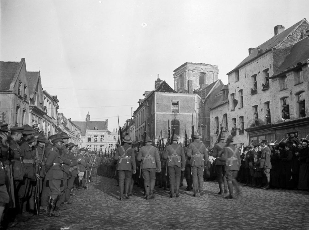New Zealand soldiers march through Le Quesnoy during Poincaré's visit. 10 November 1918.